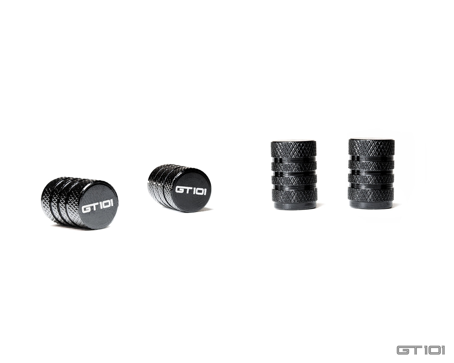 Set of four GT101 black anodised billet aluminium tyre valve dust caps with diamond-knurled bodies and laser-etched GT101 logos